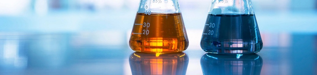 Two flasks with dark orange and blue liquid chemicals.